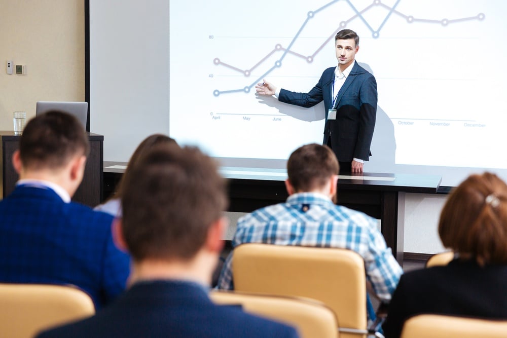 Intelligent speaker standing and lecturing at business conference in boardroom.jpeg